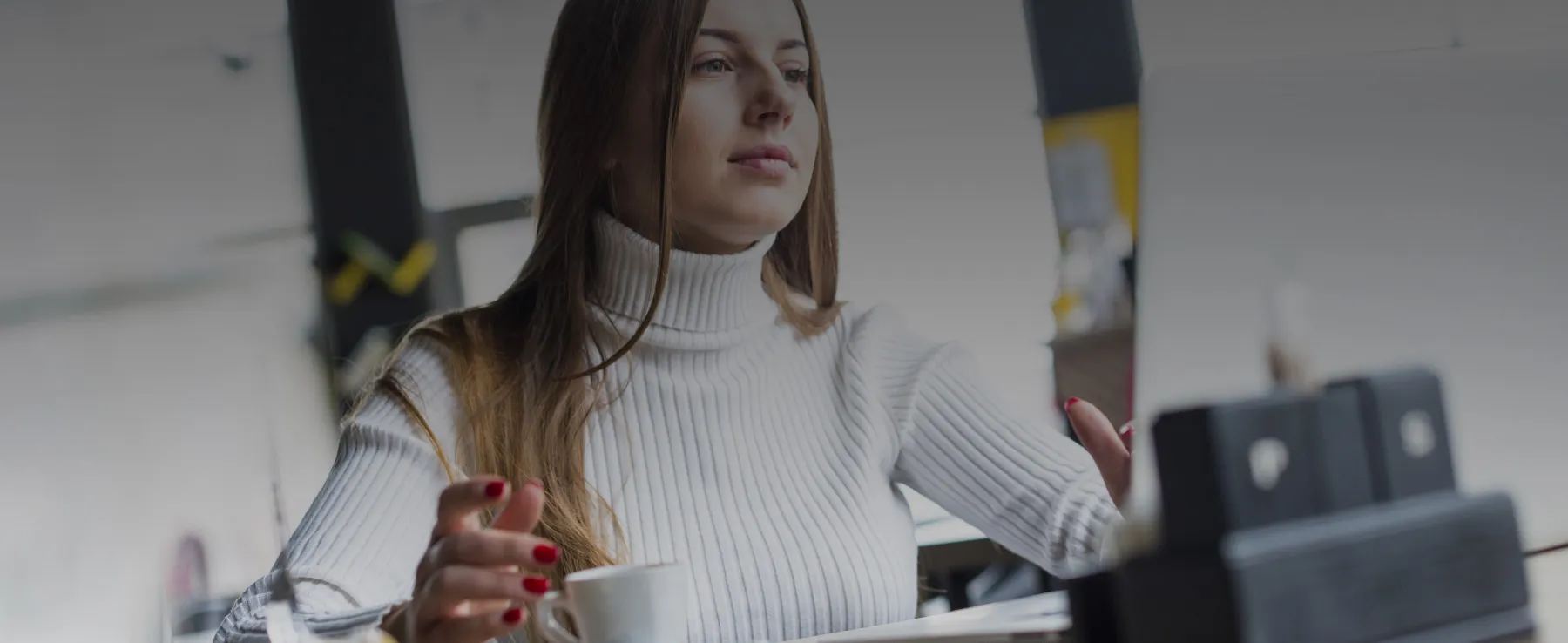 Business owner reviewing financial documents on laptop