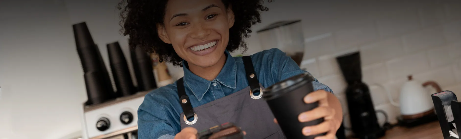 Cafe worker using an EPOS till system